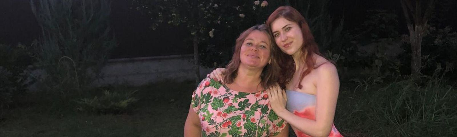 L'image montre une mère et sa fille ukrainiennes dans un jardin